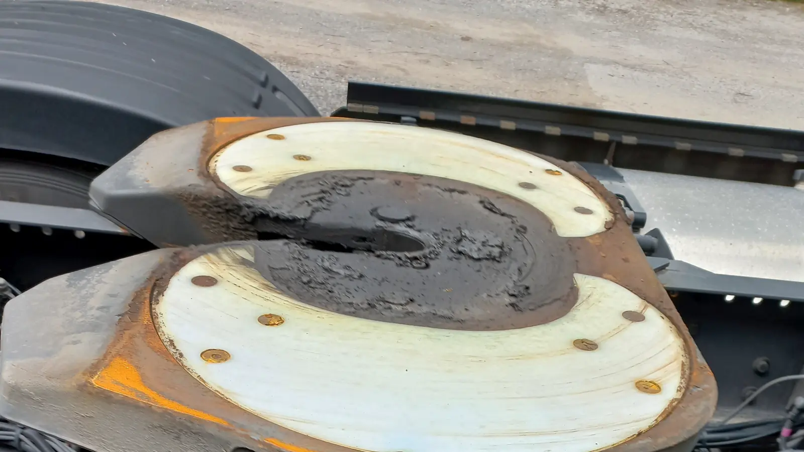 A fifth-wheel coupling plate on the rear of a tractor.